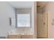 This bathroom has a garden tub, and glass-enclosed shower, and a window that lets in lots of light at 2990 Haynes Club Cir, Grayson, GA 30017