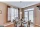 Charming dining area with a glass table, seating for four, and natural light from two windows at 2990 Haynes Club Cir, Grayson, GA 30017