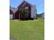 Charming two-story brick home with manicured front lawn and partial view of back yard at 2990 Haynes Club Cir, Grayson, GA 30017
