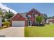 Charming two-story brick home with manicured lawn and attached two-car garage offers great curb appeal at 2990 Haynes Club Cir, Grayson, GA 30017