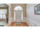 Bright and inviting foyer with hardwood floors, wainscoting, and a large window above the front door at 2990 Haynes Club Cir, Grayson, GA 30017