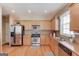Well-equipped kitchen with stainless steel appliances, wooden cabinets, and hardwood floors at 2990 Haynes Club Cir, Grayson, GA 30017