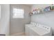 Functional laundry room with a window, a washing machine, and dryer with storage shelves at 2990 Haynes Club Cir, Grayson, GA 30017