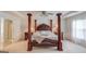 Luxurious main bedroom with a canopy bed, tray ceilings, and abundant natural light at 2990 Haynes Club Cir, Grayson, GA 30017