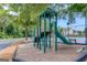 Community playground featuring climbing structure with a slide, steps, and benches near tennis courts at 2990 Haynes Club Cir, Grayson, GA 30017