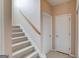 Carpeted staircase with a wooden handrail, leading to the upper level of the home at 2990 Haynes Club Cir, Grayson, GA 30017