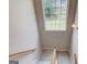 Carpeted staircase with a large window providing natural light at 2990 Haynes Club Cir, Grayson, GA 30017
