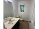 Bathroom featuring a sink with cabinet, toilet, window, and tile flooring at 172 Oak Forest Se Dr, Smyrna, GA 30082