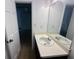 Bathroom featuring a mirror, sink with cabinet, toilet, and doorway at 172 Oak Forest Se Dr, Smyrna, GA 30082