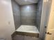 Bathroom featuring a bathtub with jacuzzi jets, gray tile, and a shower head at 172 Oak Forest Se Dr, Smyrna, GA 30082