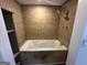 Bathroom showcasing a large soaking tub with decorative tile surround and a built-in shelf at 172 Oak Forest Se Dr, Smyrna, GA 30082