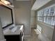 Bathroom with single sink vanity and neutral paint with natural lighting from two windows at 172 Oak Forest Se Dr, Smyrna, GA 30082