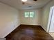 Bright bedroom featuring hardwood floors, a ceiling fan, and a window for natural light at 172 Oak Forest Se Dr, Smyrna, GA 30082
