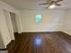 Empty bedroom with hardwood floors, closet, large window and ceiling fan at 172 Oak Forest Se Dr, Smyrna, GA 30082