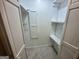 Walk-in closet featuring white shelving units, white doors, and a tile floor at 172 Oak Forest Se Dr, Smyrna, GA 30082