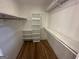 Walk-in closet featuring multiple shelving units, hanging rods, and a wood floor at 172 Oak Forest Se Dr, Smyrna, GA 30082