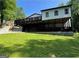 Back exterior featuring a two-story home with a large deck at 172 Oak Forest Se Dr, Smyrna, GA 30082