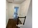 Hallway with hardwood floors, white walls, and view of bedroom and staircase at 172 Oak Forest Se Dr, Smyrna, GA 30082