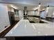 Well-equipped kitchen featuring an island with a white countertop, a stainless steel hood, and dark backsplash at 172 Oak Forest Se Dr, Smyrna, GA 30082