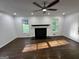 Bright living room featuring hardwood floors, a ceiling fan, a fireplace, and large windows at 172 Oak Forest Se Dr, Smyrna, GA 30082