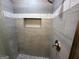 Walk-in shower featuring gray tile walls, a shower head, and a built-in niche at 172 Oak Forest Se Dr, Smyrna, GA 30082