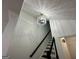 Staircase with hardwood steps and black railing leading to a chandelier fixture at 172 Oak Forest Se Dr, Smyrna, GA 30082