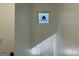Staircase with stained glass window above and a chandelier visible further down the steps at 172 Oak Forest Se Dr, Smyrna, GA 30082