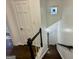 Staircase with hardwood floors, black and white railings and decorative stained glass window at 172 Oak Forest Se Dr, Smyrna, GA 30082