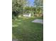 Spacious backyard with green grass, storage shed, wooden fence and mature trees at 113 Ausband Dr, Mcdonough, GA 30253
