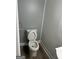 Cozy half bathroom featuring beadboard wall, gray paint and wood-look flooring at 113 Ausband Dr, Mcdonough, GA 30253