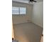 This is a standard bedroom with carpeted floors and natural light from a window at 113 Ausband Dr, Mcdonough, GA 30253