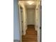 Hallway featuring hardwood floors and white trim at 113 Ausband Dr, Mcdonough, GA 30253