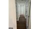 Long hallway featuring hardwood floors and white trim at 113 Ausband Dr, Mcdonough, GA 30253