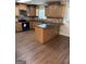 Updated kitchen with granite countertops, wooden cabinets, and an island at 113 Ausband Dr, Mcdonough, GA 30253