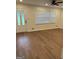 Bright living room featuring wood floors, fan and ample natural light through a large window at 113 Ausband Dr, Mcdonough, GA 30253