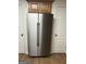 Stainless steel Maytag refrigerator with side-by-side doors and overhead wooden cabinet at 113 Ausband Dr, Mcdonough, GA 30253