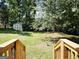 View of lush backyard with mature trees, greenery, and a shed at 6698 Cameron Rd, Morrow, GA 30260