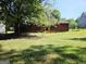 Spacious backyard of a home with mature trees, a fenced border, and a well-maintained lawn at 6698 Cameron Rd, Morrow, GA 30260