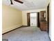 Basement featuring neutral carpeting, bi-fold doors and utility storage at 6698 Cameron Rd, Morrow, GA 30260