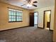 Spacious bedroom with neutral carpet, ceiling fan, and natural light at 6698 Cameron Rd, Morrow, GA 30260