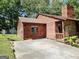 Exterior view of home with stone accent and wooden siding with ample parking space at 6698 Cameron Rd, Morrow, GA 30260