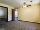 Spacious room with neutral carpeting, drop ceiling and doorway leading to additional rooms at 6698 Cameron Rd, Morrow, GA 30260