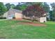 Spacious backyard with mature landscaping, offering shade and privacy with manicured lawn at 221 Ashley Oaks Dr, Mcdonough, GA 30253