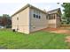 Rear of home features screened-in porch, traditional siding, manicured landscaping, and backyard at 221 Ashley Oaks Dr, Mcdonough, GA 30253