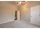 Neutral bedroom featuring vaulted ceiling with ceiling fan, neutral carpet, and an open door at 221 Ashley Oaks Dr, Mcdonough, GA 30253