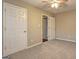 Bedroom with carpeted floors, closet and view into another room at 221 Ashley Oaks Dr, Mcdonough, GA 30253