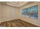 Bright dining room features modern chandelier, large window and beautiful wood floors at 221 Ashley Oaks Dr, Mcdonough, GA 30253