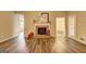 Bright living room with wood-look floors, a brick fireplace and natural light at 221 Ashley Oaks Dr, Mcdonough, GA 30253