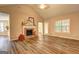 Inviting living room features a brick fireplace, vaulted ceilings, and wood-look flooring at 221 Ashley Oaks Dr, Mcdonough, GA 30253