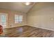 Sun-filled living room with wood flooring, vaulted ceilings, and access to the outdoor patio at 221 Ashley Oaks Dr, Mcdonough, GA 30253
